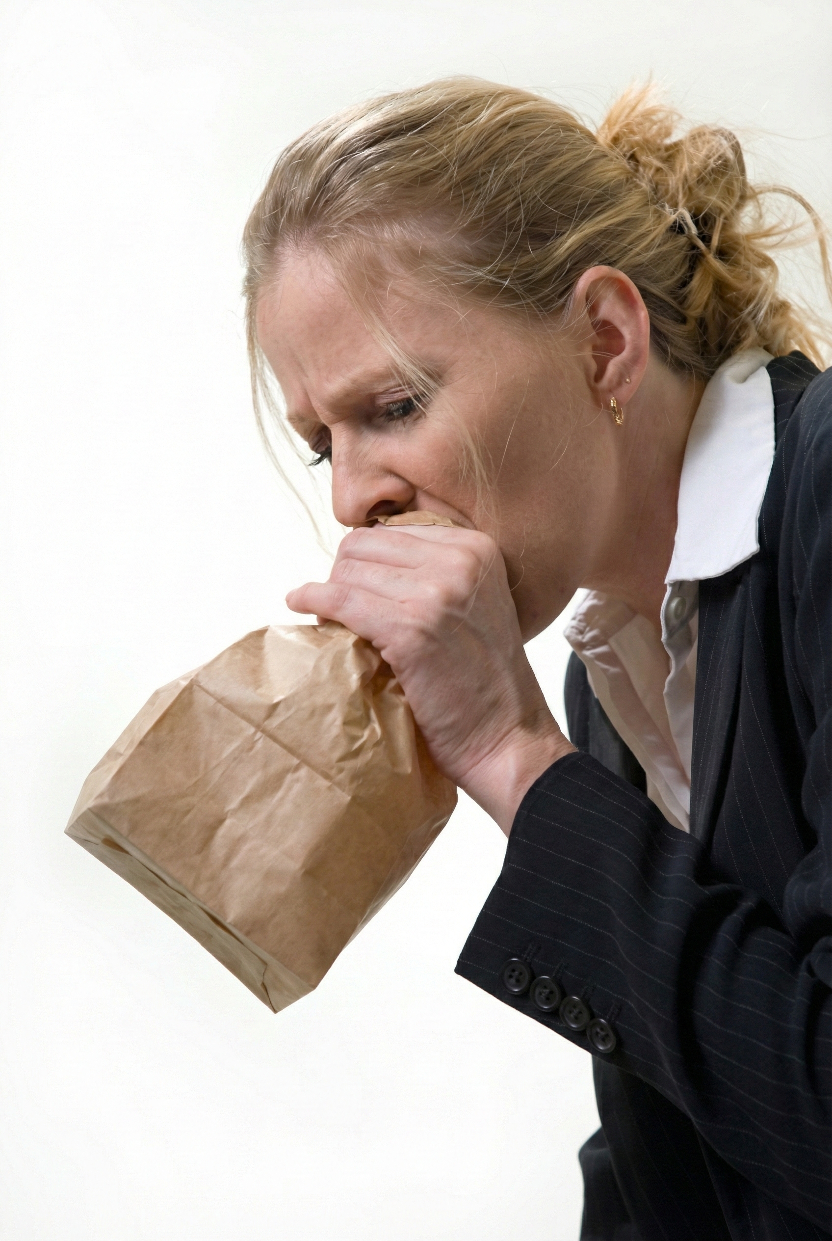 Person breathing into paper bag