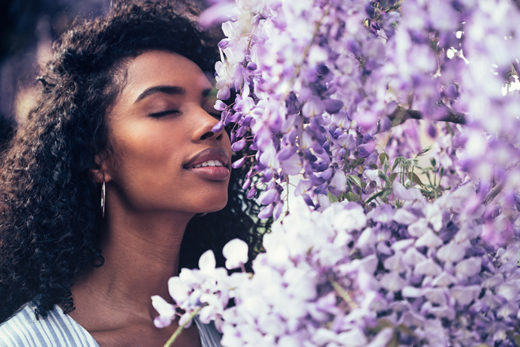 Person smelling a flower
