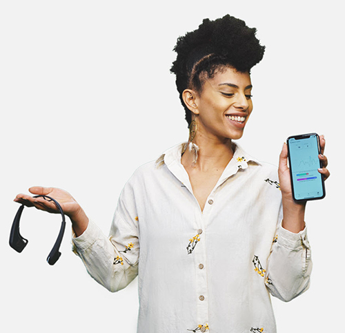 Person holding a Myndlift EEG headband in one hand and a smartphone displaying the Myndlift app in the other