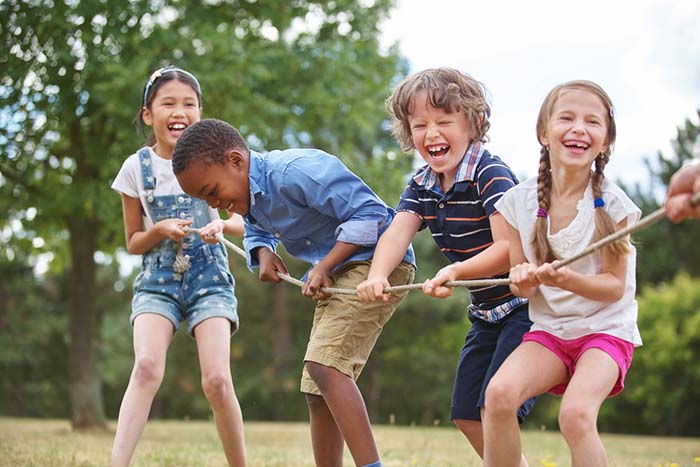 Children playing outdoors, demonstrating the stress-relieving benefits of play