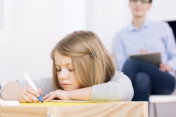Classroom setting showing behavioral observation of a child during academic activities