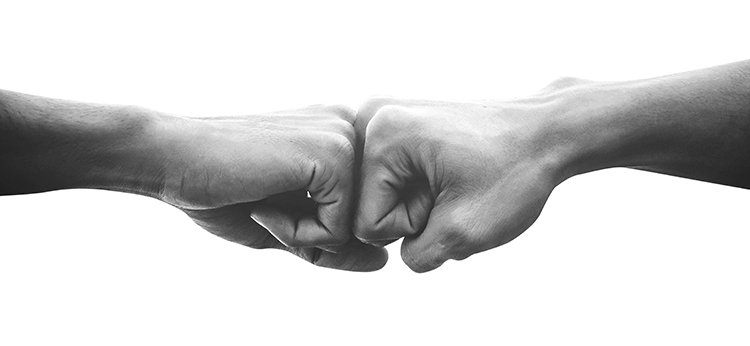 Therapist and client fist bump illustrating the therapeutic relationship